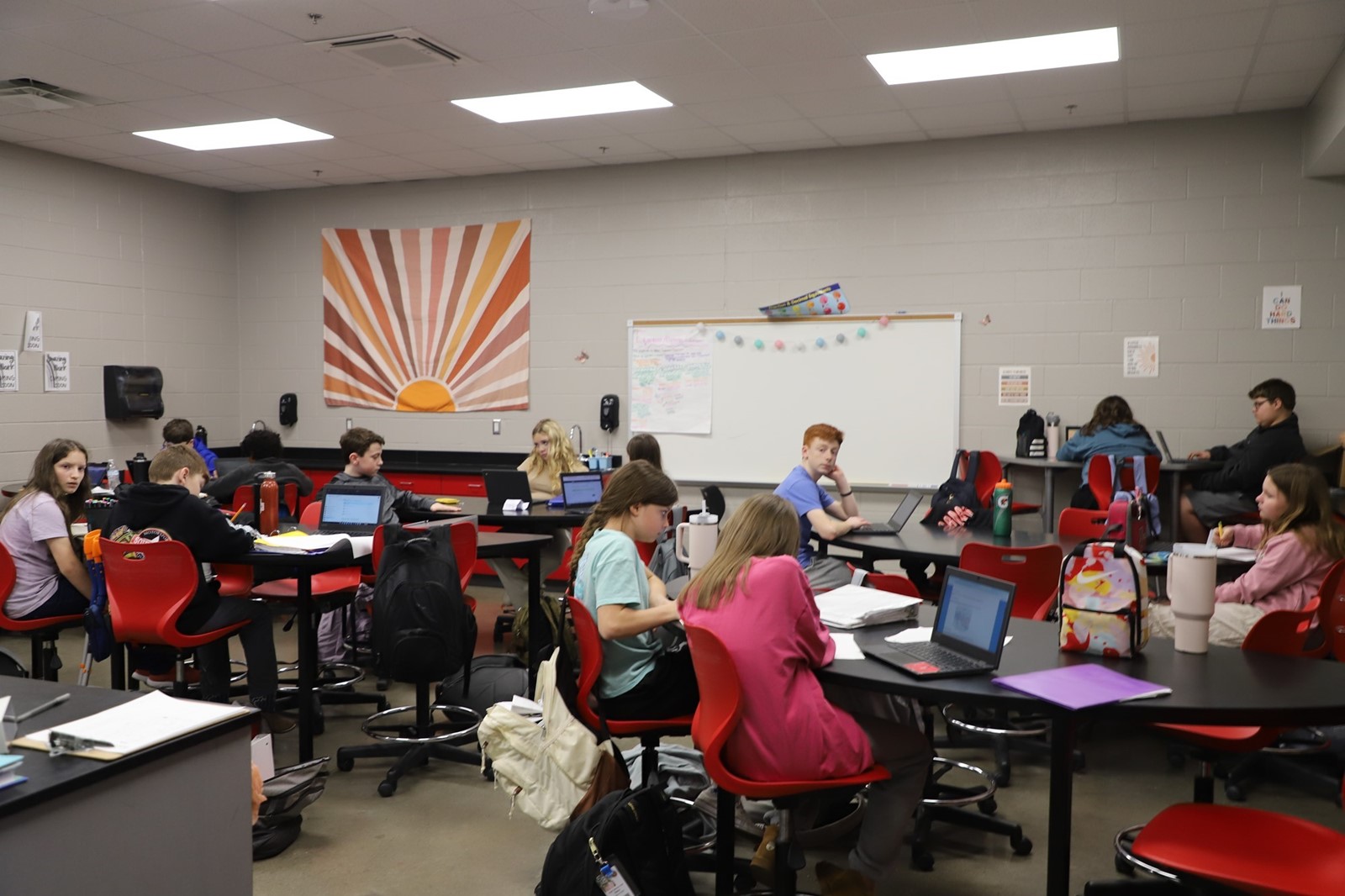 Students work in a classroom. 